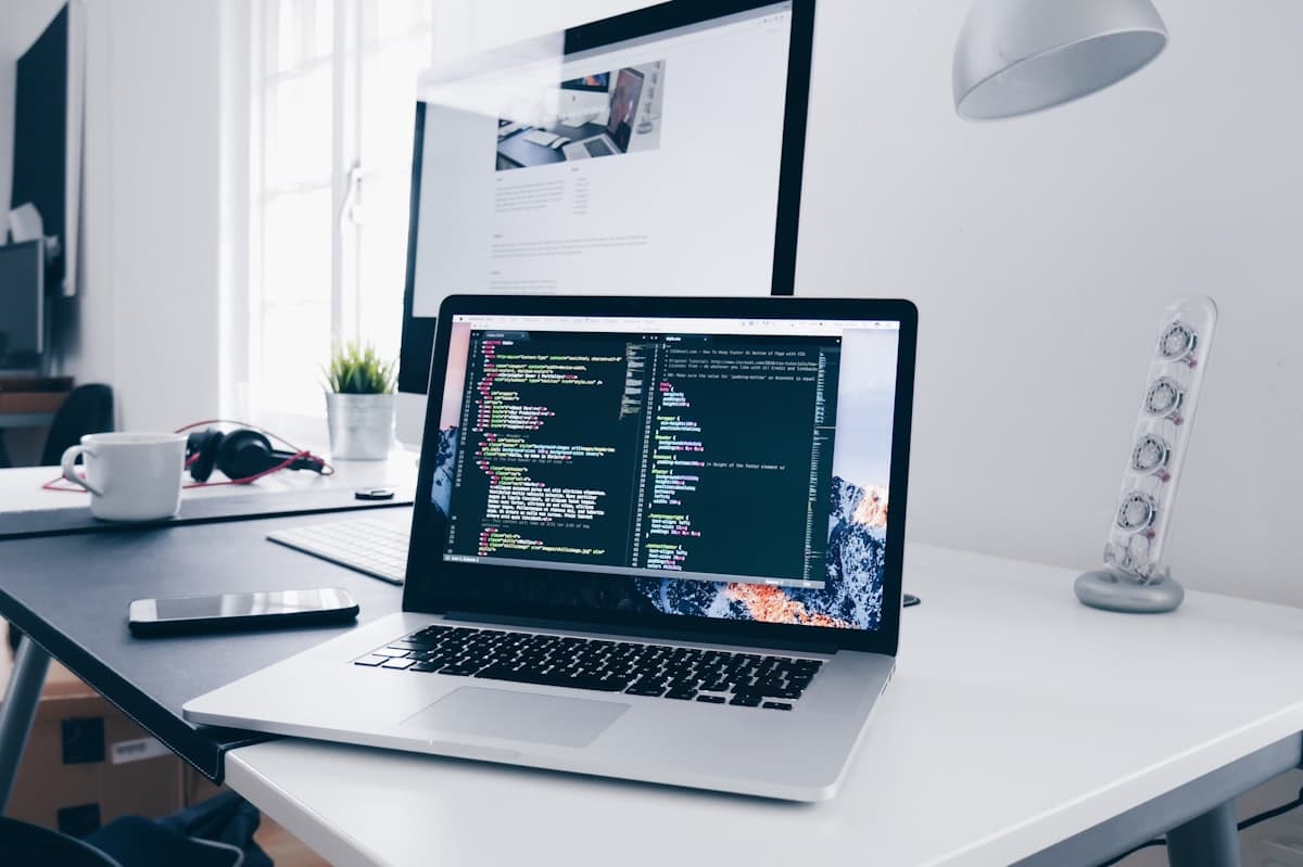 Developer writing code on laptop